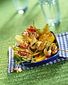 Barbecued chicken kebabs on a bed of vegetables