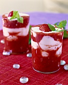Two glasses of layered strawberry and yoghurt dessert