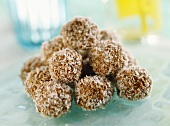 A pyramid of carob balls with grated coconut