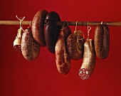 Several black puddings hanging on a pole