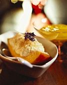 Wedge of mango topped with curd cheese & coconut flakes