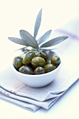 Green olives in a white bowl