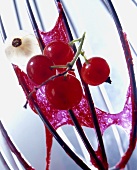 Whisk with redcurrant jelly and redcurrants