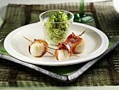 Three scallops wrapped in ham with herb butter