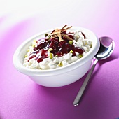 Rice pudding with cranberry sauce and pieces of pistachio
