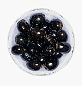 Black olives in a small glass bowl