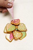 Heart-shaped butter biscuits being decorating