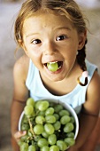 Girl with grape in her mouth
