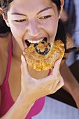 Young woman eating sweet pastry
