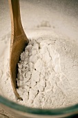 Wooden spoon in flour