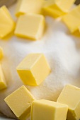 Several butter cubes with sugar