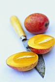 Two mini-mangos, one halved