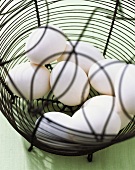 White eggs in wire basket