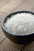 Brown bowl full of long-grain rice