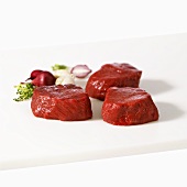Three beef medallions on white background