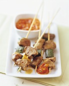 Lamb kebabs with courgettes and tomato sauce