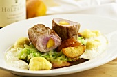 Pork fillet stuffed with apricot on cabbage with dumplings