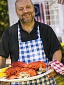Man serving seafood platter for 4th of July (USA)