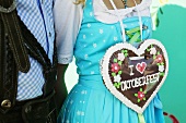 Woman in national dress with Lebkuchen heart (Oktoberfest, Munich)