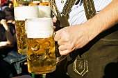 Man in national dress with 3 litres of beer (Oktoberfest, Munich)