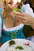 Girl eating bread and chives in a beer garden