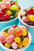 Coloured jelly beans in beakers
