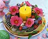 Easter wreath with primulas and burning candle
