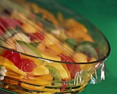 Fruit salad in glass bowl covered with clingfilm