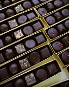 Assorted chocolates in gold boxes