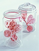 Pink lollipops in storage jars
