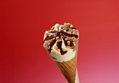Chocolate & vanilla ice cream cone with nuts & chocolate sauce