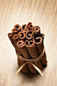 Cinnamon sticks on wooden background