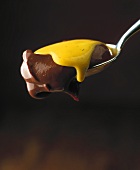 Chocolate cream with saffron cream on spoon