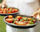 Tomatoes with pepper and basil
