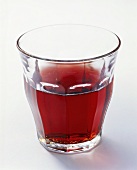 Red wine in water glass