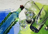 Schnapps glass and water glass on sheet of wet glass