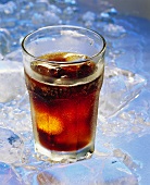 A glass of Cola with ice cubes