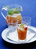 Fruit tea with fresh strawberries and ice cubes