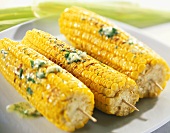Barbecued corncobs with herb butter