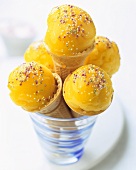 Mango sorbet with sprinkles in ice cream cones