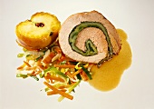 Rolled pork roast with apple, vegetables and beer sauce