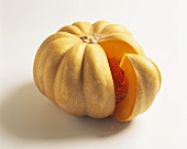 A pumpkin, with a slice cut out