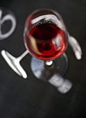 A glass of red wine on a grey background