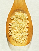 Parboiled rice on wooden spoon