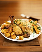 Chicken with fried potatoes, vegetables and herbs