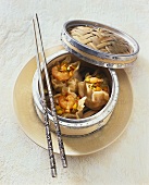 Dim sum with shrimps in small bamboo basket (China)