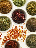Various herb teas (dry) in small white bowls