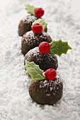 Rum truffles on icing sugar (decorated for Christmas)
