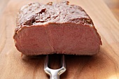 Beef fillet, a piece cut off, with meat fork