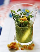 Herb soup with croutons in glass